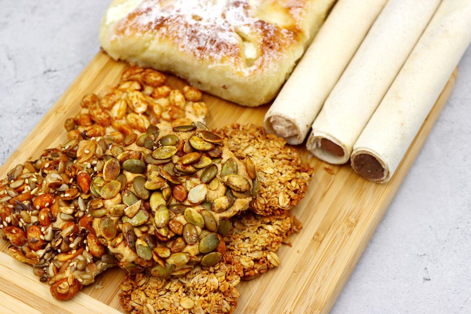 Assorted pastries with nuts and seeds on a wooden board